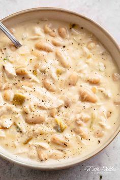 a bowl of chicken and dumpling soup with a spoon in it