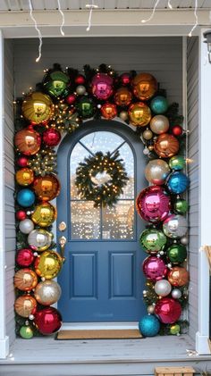 a blue front door decorated with ornaments and a wreath for the entrance to a house