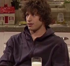 a man sitting down with a glass of milk