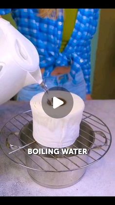 a person pouring water into a basket with toilet paper