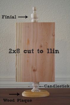 a wooden cutting board sitting on top of a table next to a candle holder with the measurements