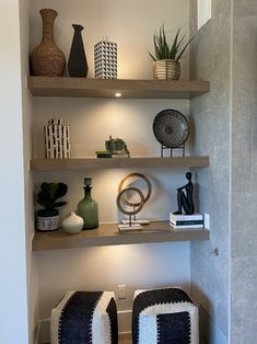 some shelves with vases and other items on them