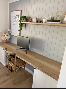 a wooden desk with a tv on top of it next to a shelf filled with books