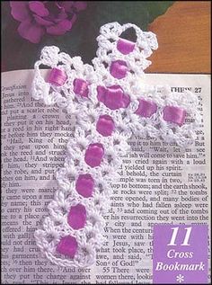 a crocheted cross sitting on top of an open book