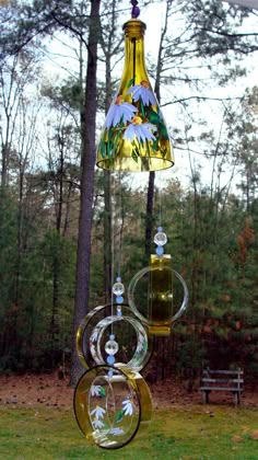 a glass wind chime hanging from a tree