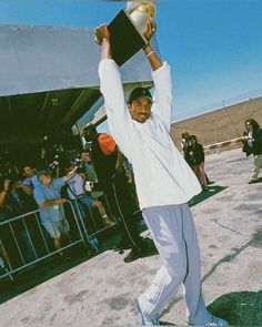 a man holding up a trophy in front of a crowd