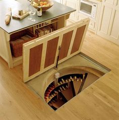 an open hole in the floor with wine bottles inside