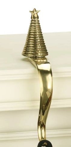 a gold trophy with a black base and a star on it's top is standing in front of a white wall