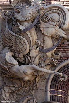 an intricately carved gargoyle on the side of a building