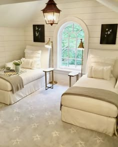 a bedroom with white walls and flooring has two beds in it, one on the other side