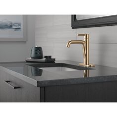 a bathroom sink with a faucet and soap dispenser on the counter