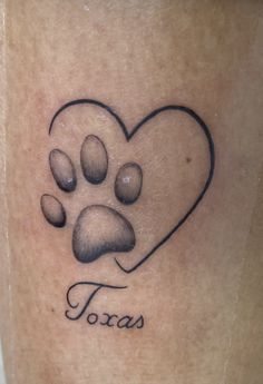 a dog paw tattoo with the word texas written in it and a heart shaped paw