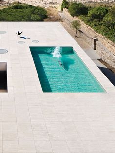 an aerial view of a swimming pool with a person in it