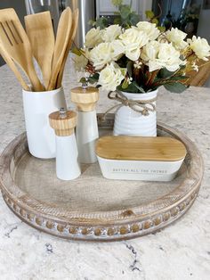 a tray with utensils and flowers on it