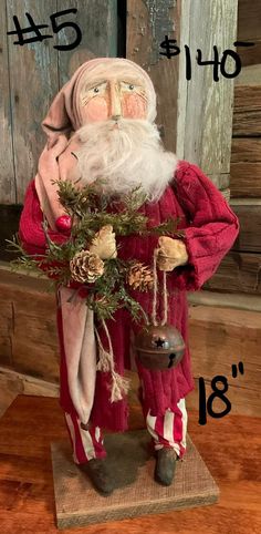 a santa clause figurine holding a potted plant in front of a wooden wall