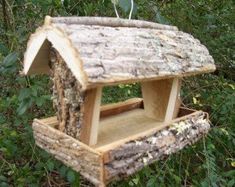 a bird house made out of wood in the woods