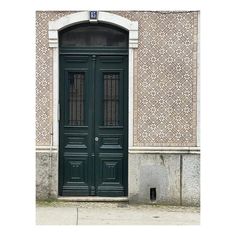 a green door on the side of a building