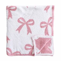 a pink and white blanket with bows on it