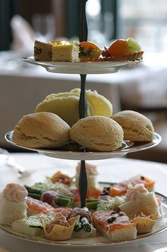 three tiered trays filled with different types of food