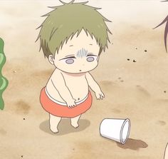 a young boy standing on top of a sandy beach next to a white cup and plant