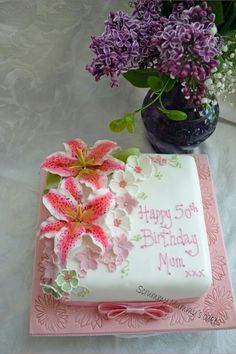 a birthday cake with pink flowers on it