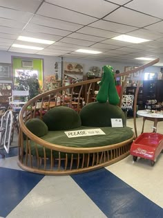 a green couch sitting on top of a checkered floor next to a red chair