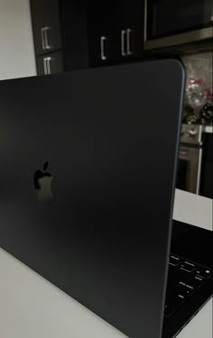 an apple laptop computer sitting on top of a counter