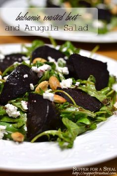 a salad with beets, feta cheese and almonds is on a white plate