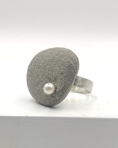 Concrete ring 925 Sterling Silver for women. A handcrafted ring made with 925 Sterling Silver and adorned with one asymmetric concrete charm, adorned with one white freshwater pearl!  A statement ring for appearances to be discussed! Freshwater pearl is June's birthstone! In contact with skin, moisture and air, concrete becomes darker. Αs each piece is individually handmade, slight variations in  texture are possible. DESCRIPTIONS and MEASUREMENTS: Material:sterling silver . Material: Concrete ,freshwater pearl. Dimensions concrete: 2,6*3,3cm 1,023*1,29 Size ring in photo: 7,5 USA size SEE MORE CONCRETE JEWELRY HERE: www.etsy.com/shop/ArtisJewels?ref=seller-platform-mcnav§ion_id=36353295 Visit my Etsy shop, ArtisJewels, to see more rings and jewelry and other unique handmade pieces. www.et Concrete Ring, Architectural Jewelry, Concrete Jewelry, Square Rings, Handcrafted Rings, White Freshwater Pearl, June Birth Stone, Silver Material, Statement Ring