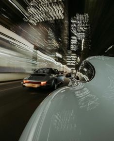 a car driving down a street next to tall buildings