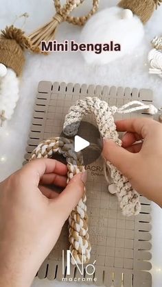 someone is working with yarn on a piece of paper that has been made to look like an ornament