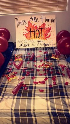 there are balloons and confetti on the bed with a sign that says, these are autumn hot