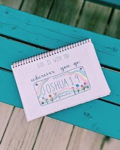 a notepad sitting on top of a wooden bench