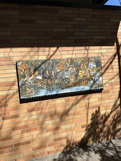 a painting on the side of a brick building with animals painted on it's wall