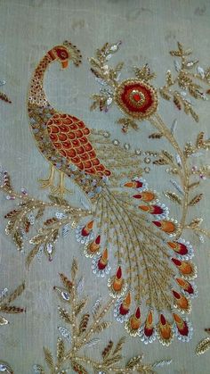 an embroidered fabric with a peacock on it