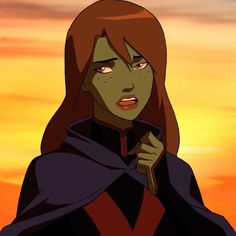 a woman with red hair wearing a cape and holding a knife in front of an orange sky