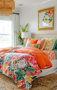 a bed with colorful comforters and pillows in a room