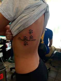 a woman with a dog paw tattoo on her stomach