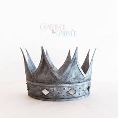 a metal crown sitting on top of a white table