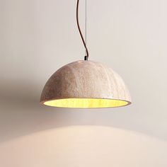 a light that is hanging from a ceiling in a room with a white wall behind it