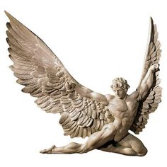 a statue of an angel sitting on the ground with its wings spread out and outstretched