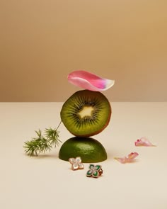 the kiwi is cut in half and placed on top of other pieces of fruit