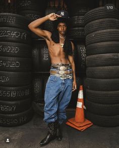 a man standing in front of stacks of tires