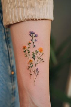 a woman's arm with flowers on it