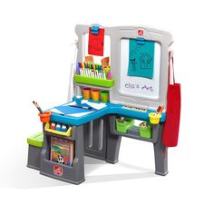 a child's desk and chair with toys on it