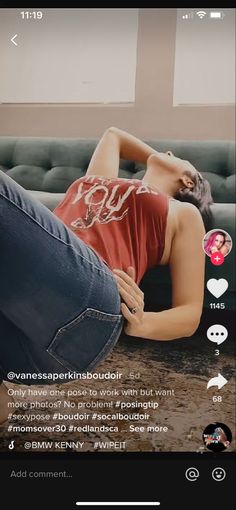 a woman laying on top of a couch next to a man in red shirt and jeans