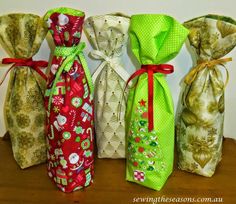 four different types of wine bags lined up on top of a wooden table next to each other