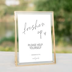 a sign that says please help yourself on the side of a white table cloth covered table