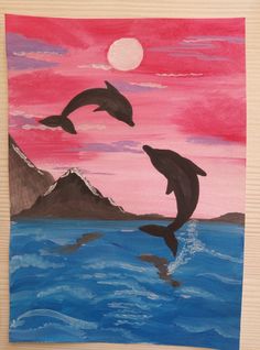 two dolphins jumping out of the water in front of a pink and blue sky at sunset