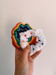 a hand holding up a crocheted hair scrunch